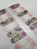 Dégradé ombré scintillant rose et blanc avec des fleurs violettes et jaunes